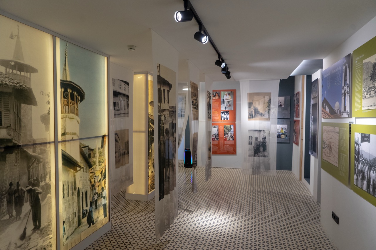 Framed Antakya photographs displayed along a museum wall